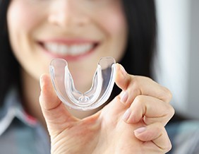 Close-up of woman holding mouthguard