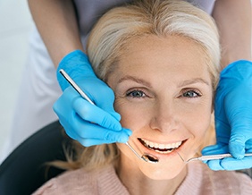 A woman smiling with dental implants