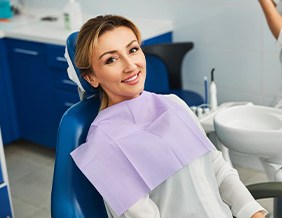 Woman smiling while sitting in treatment chair