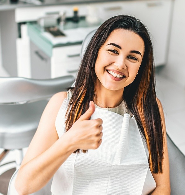 Smiling woman in dental chair after dental checkup