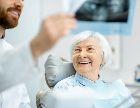 Dentist and patient looking at dental x-rays