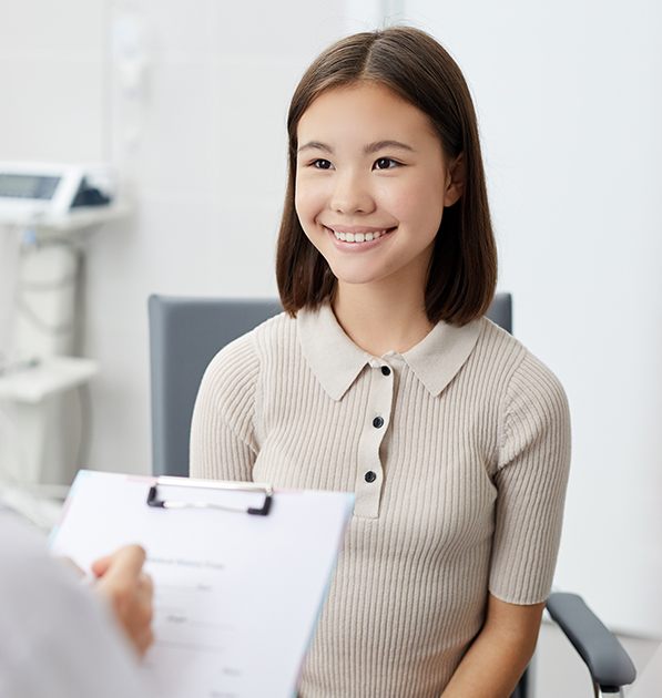 Preteen girl smiling during dental checkup