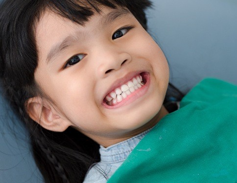 Child smiling after tooth-colored filling placement