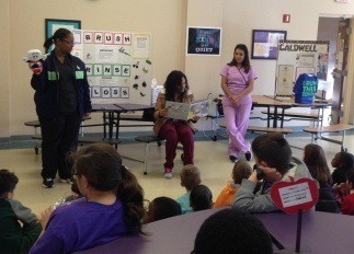 Team members talking to kids about oral health
