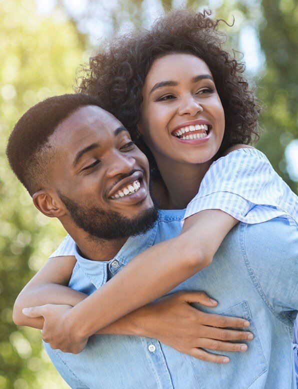 Smiling man and woman outdoors