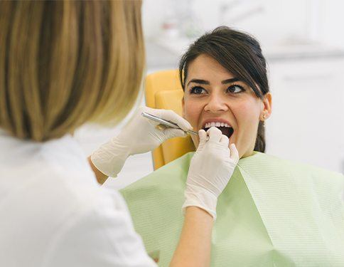 Woman receiving preventive dentistry covered by dental insurance