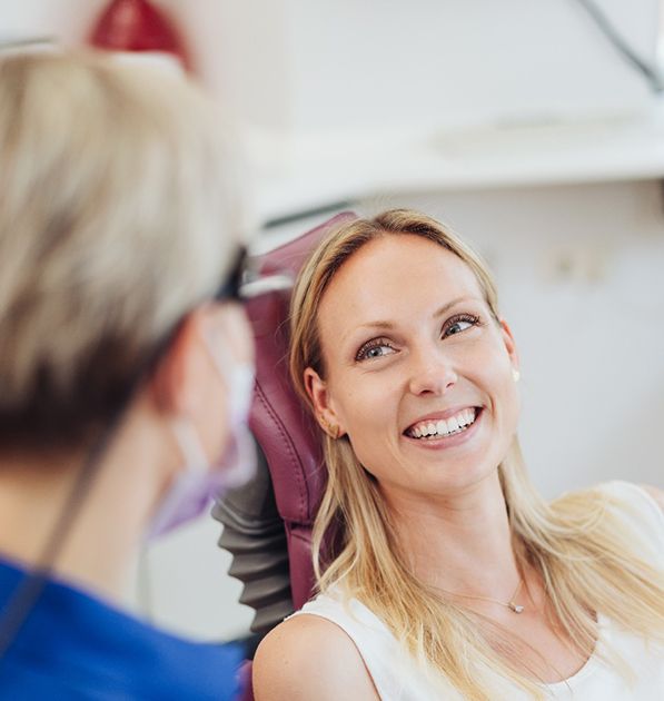 Woman smiling while talking to the dentist