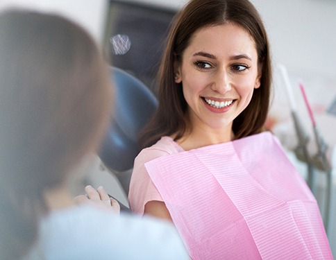 Woman smiling at dentist during appointment
