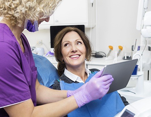 Woman smiling at dentist during dental checkup