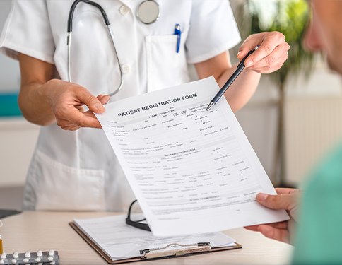 Team member showing patient dental insurance forms