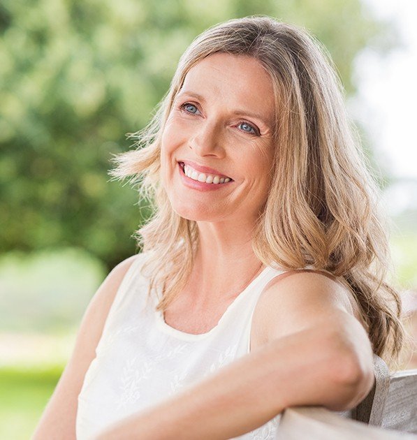 Woman sharing healthy smile after tooth-colored filling placement