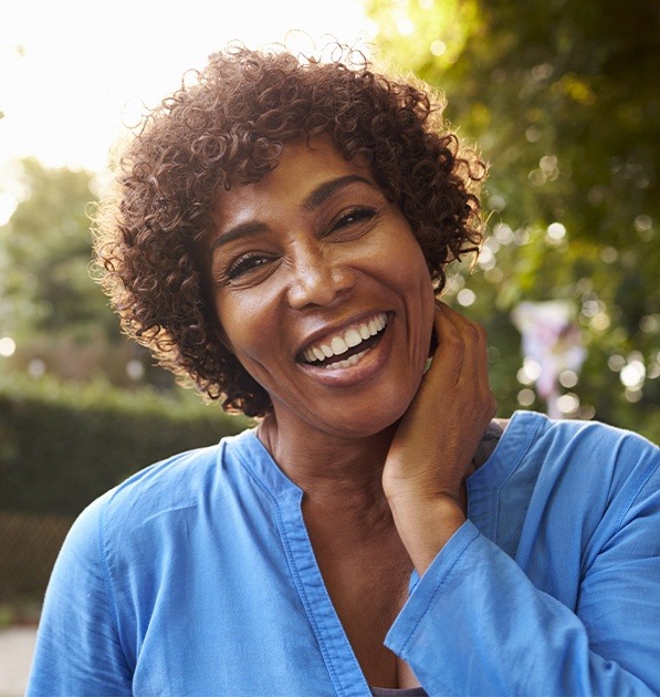 Woman with beautiful smile after porcelain veneers