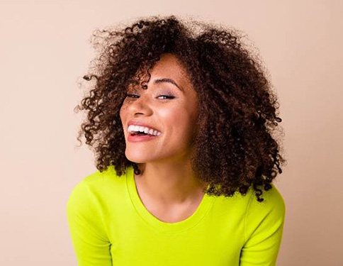 Woman in neon green shirt smiling