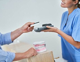 Patient using credit card to pay for dental treatment