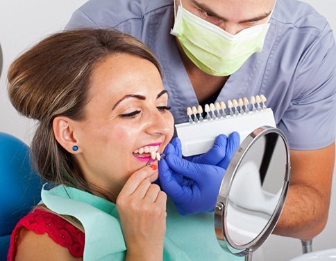 woman in red shirt trying on veneers in Tyler 