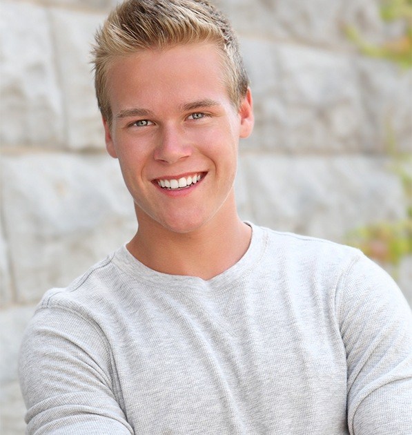 Teen boy smiling after wisdom tooth extraction