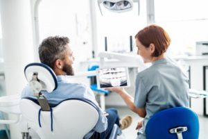 a man speaking to his dentist at his checkup 