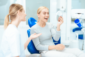 a patient smiling while visiting their dentist