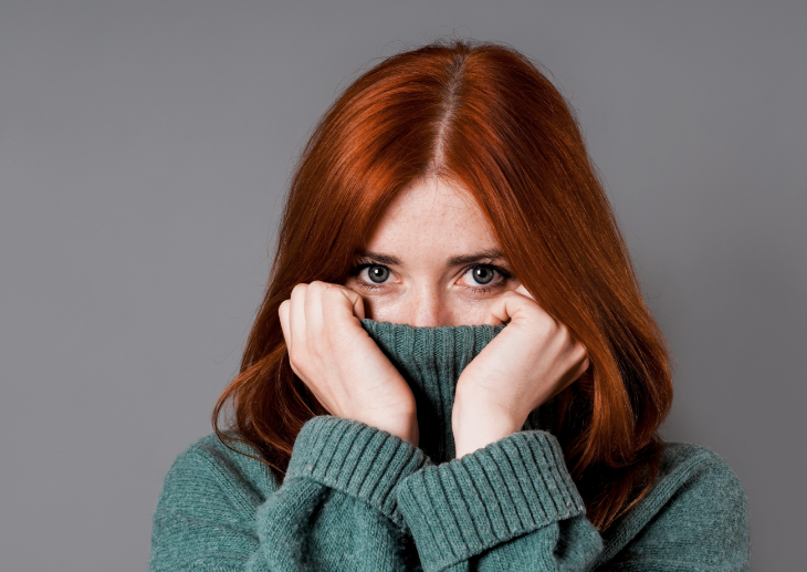Woman hiding mouth in turtle neck
