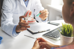 a patient consulting with a dentist about implant dentures